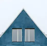 Blue triangular house top with two rectangular windows.