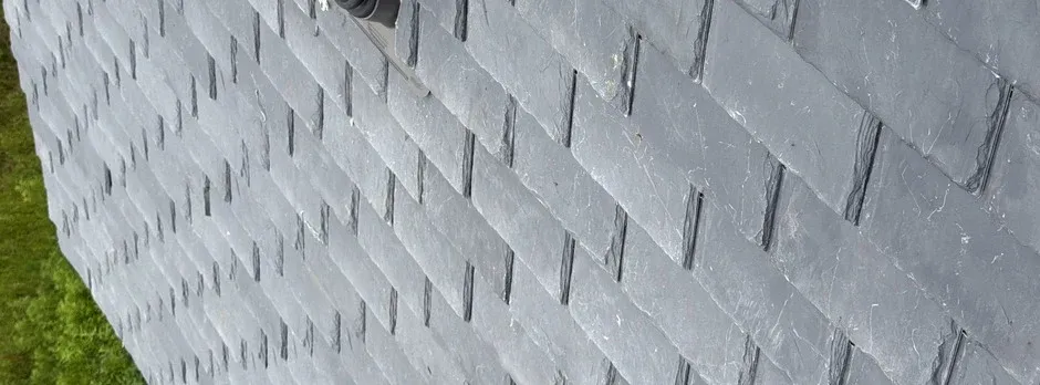 Close-up texture of natural slate roofing tiles.
