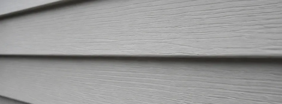 Close-up texture of horizontal vinyl lap siding.