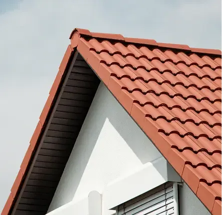 Terracotta tiled gable end against a white exterior wall.